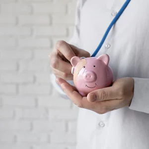 close-up-hands-holding-piggy-bank